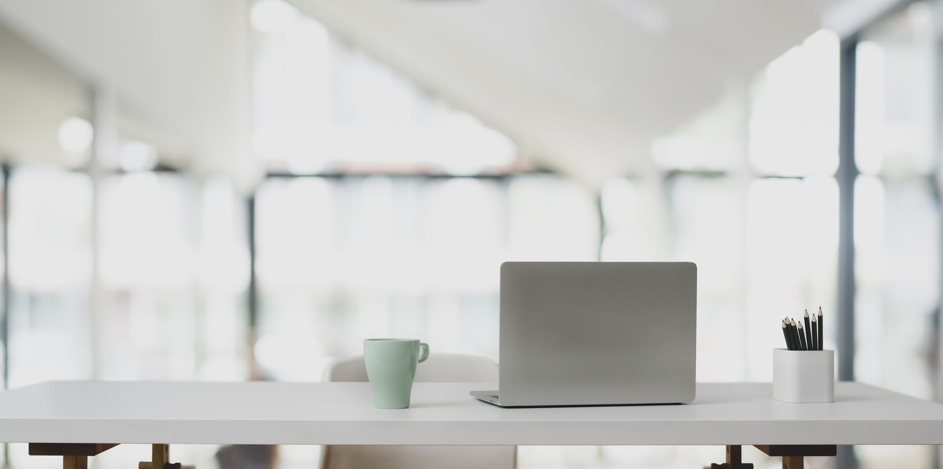 silver laptop in white wooden table